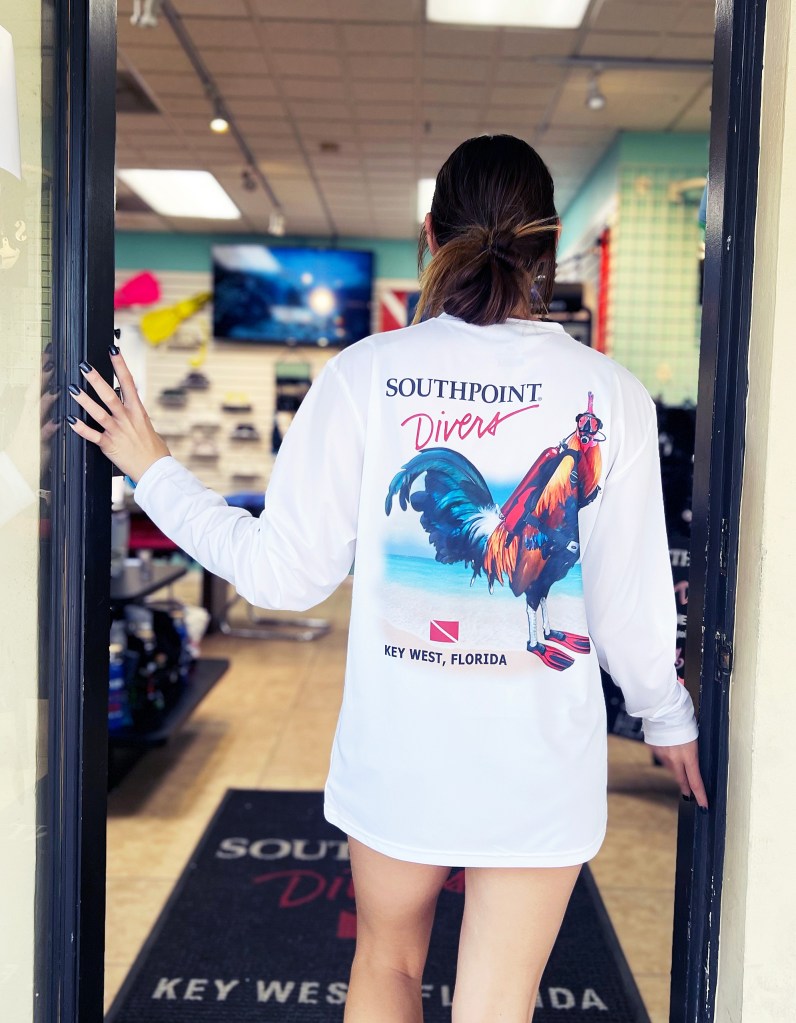 Person in Southpoint Divers shirt entering a store.